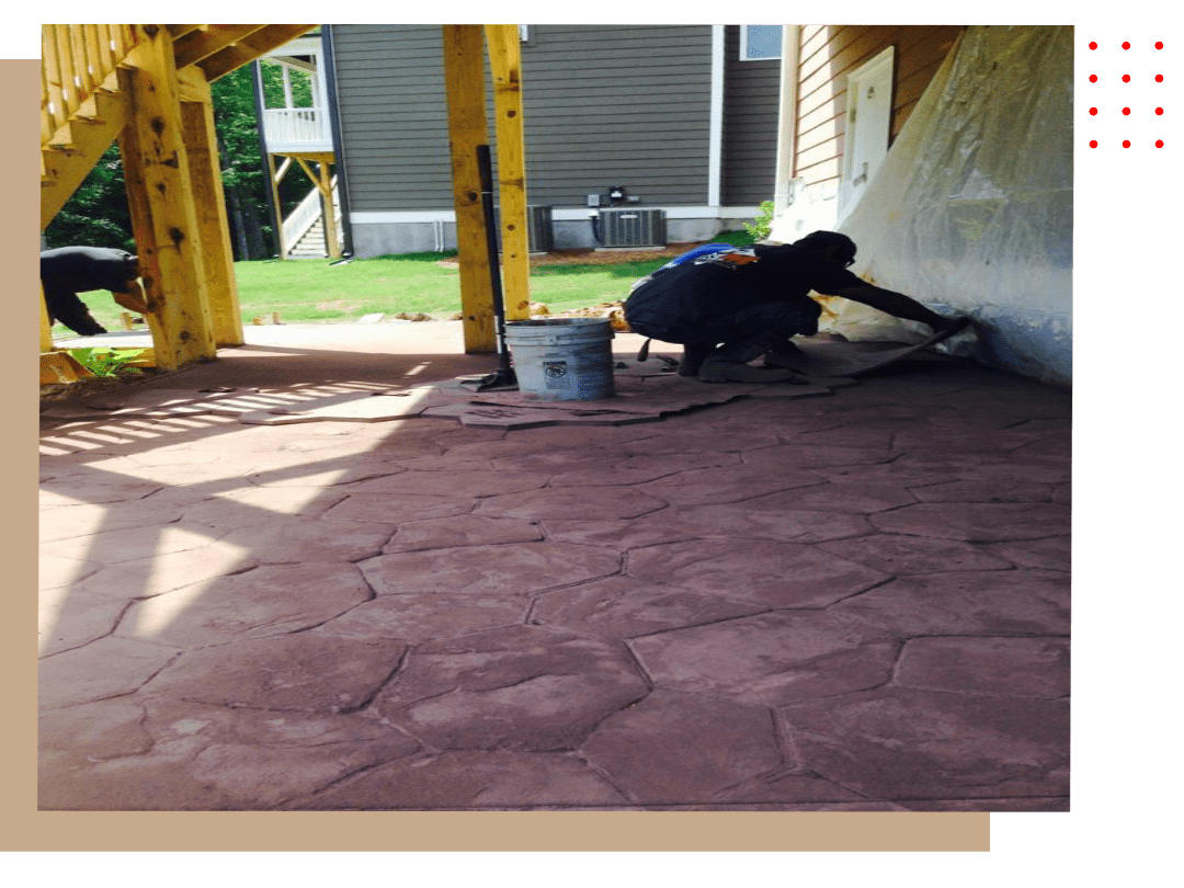A person is painting the floor of an outdoor area.