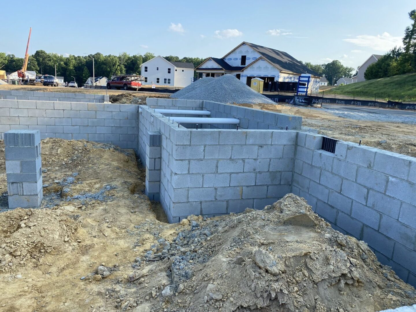 A building site with concrete blocks and a hole in the ground.